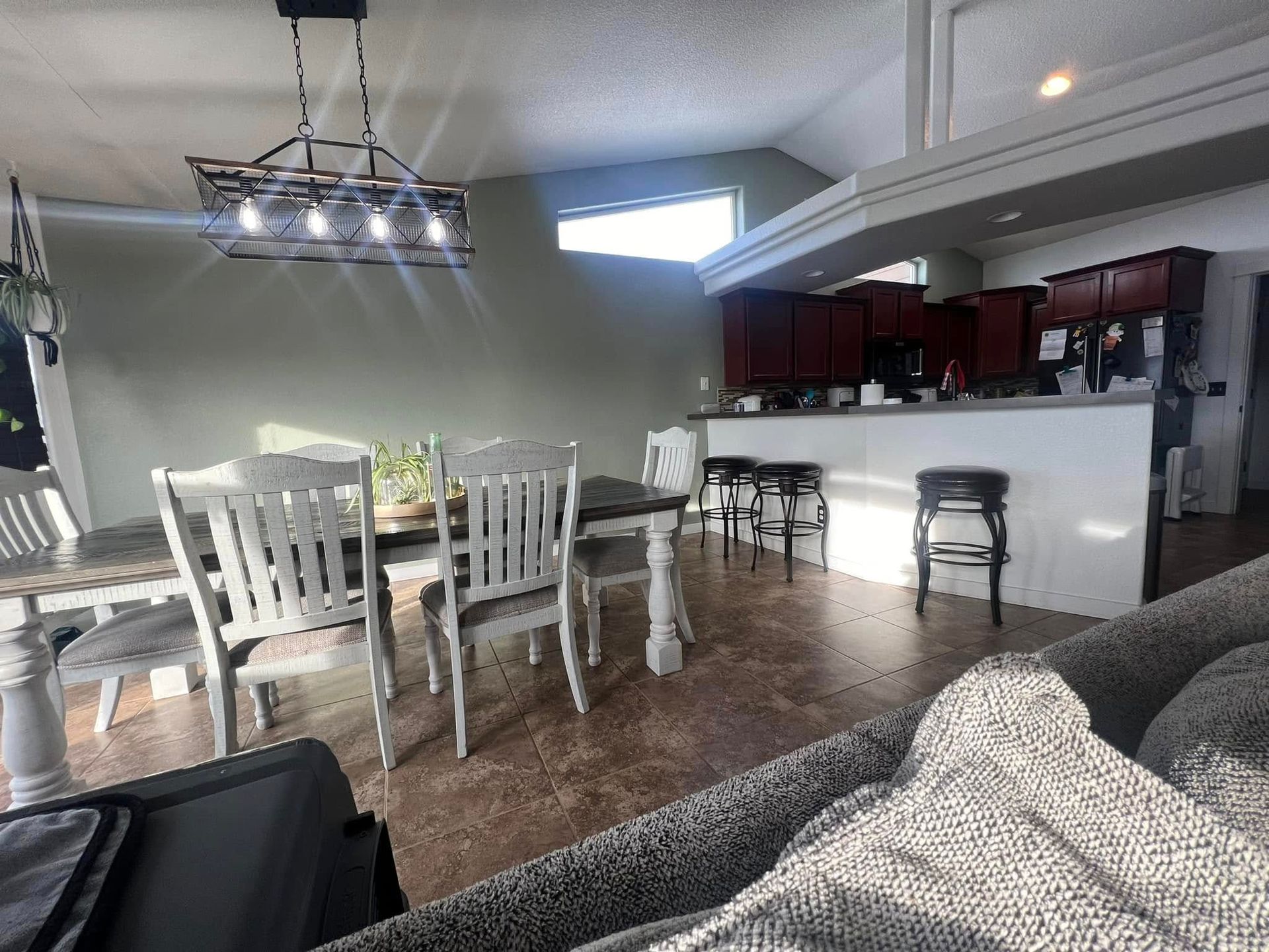 A living room with a table and chairs in it