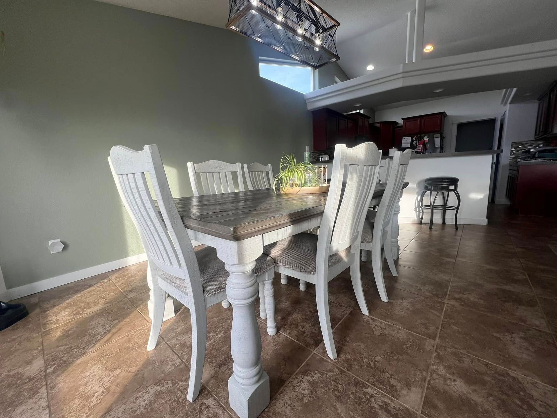 A dining room table and chairs in a house.