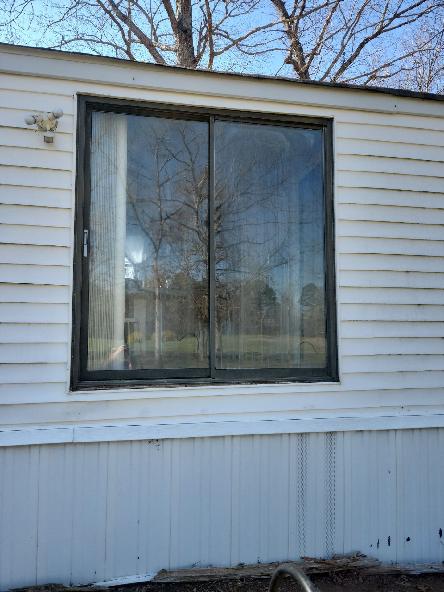 A mobile home with a large window on the side of it.