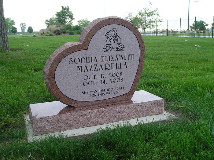 A brown heart shaped gravestone