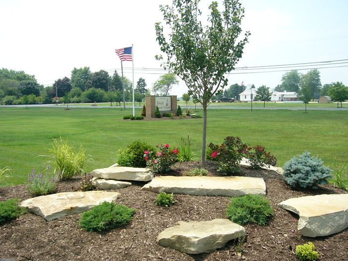 A lush green field with a flag in the background