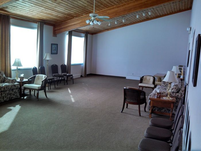 A living room with a lot of furniture and a ceiling fan