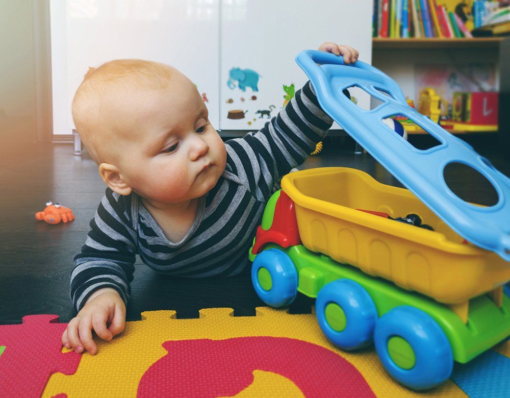 A Baby Playing Toys — Chicago, IL — Metropolitan Insurance Service Consultants, Inc