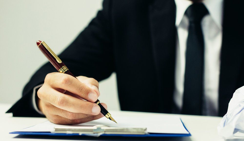 Person Signing A Contract — Chicago, IL — Metropolitan Insurance Service Consultants, Inc