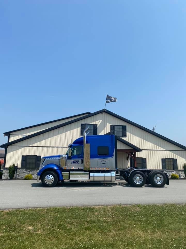 A GFI Transport semi truck is parked in a parking lot ready for cocoa beans shipping.