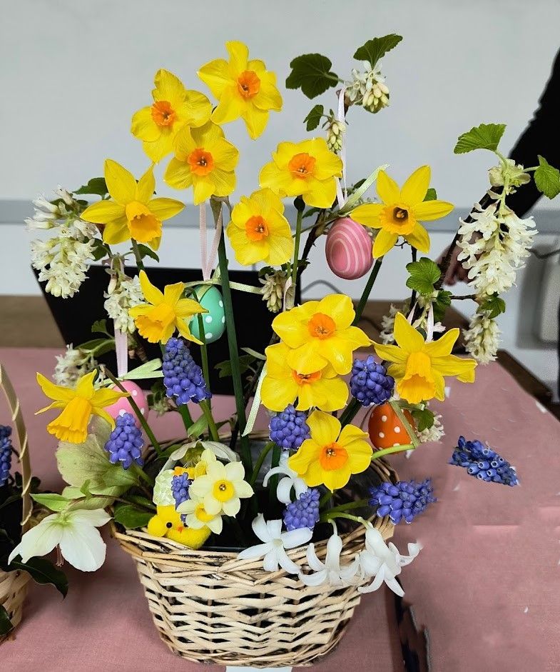 1st prize: Jen G.  Arrangement in light coloured wicker basked with various narcissi, muscari, painted eggs and other flower and foliage.