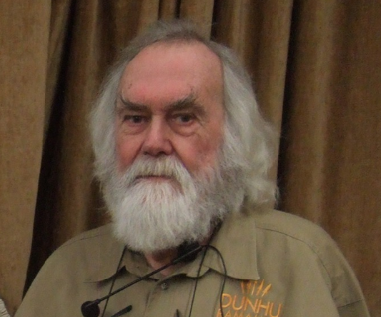 photo of a beekeeper in a field
