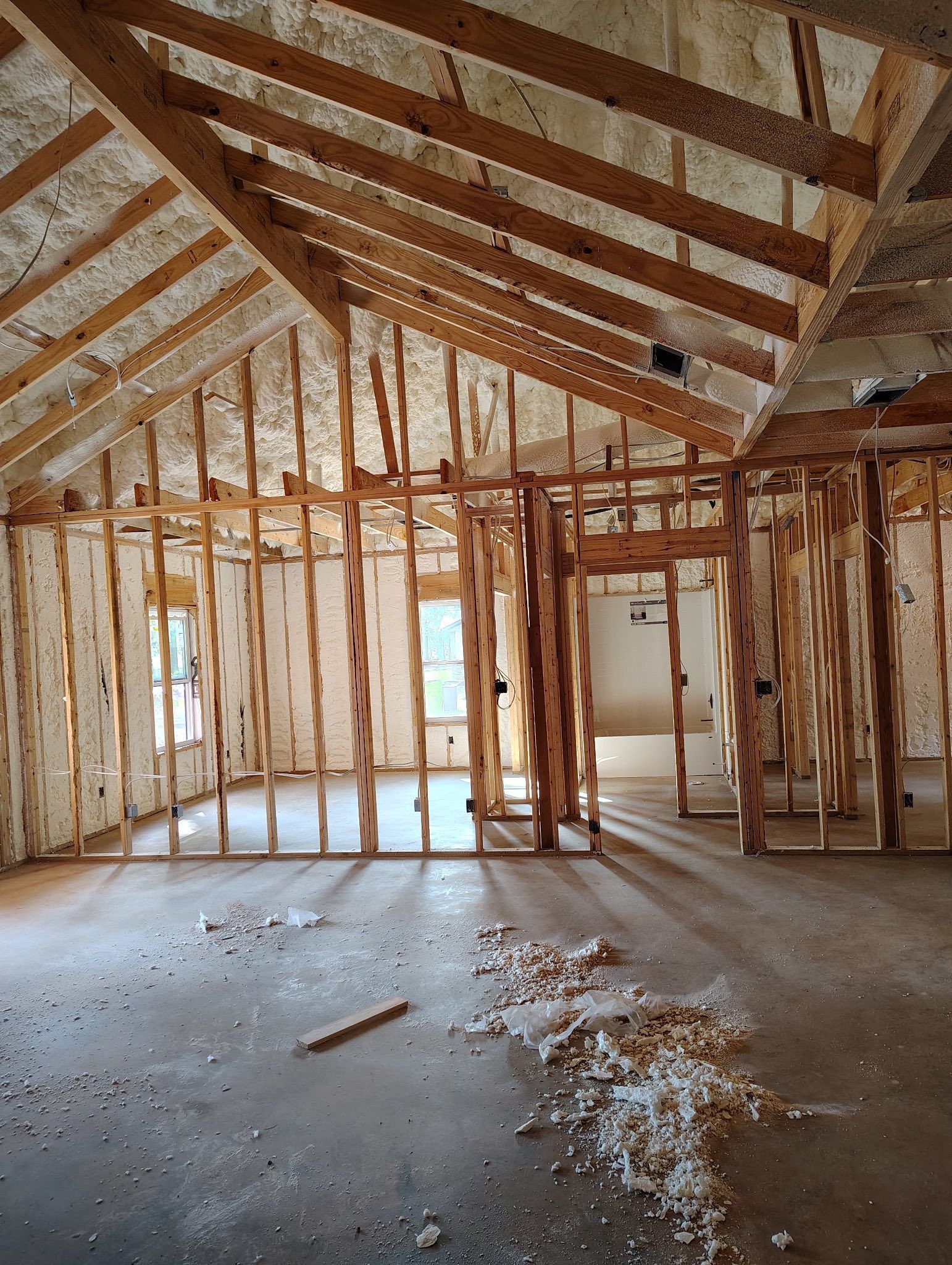 Interior of a building under construction, showing wooden framing and insulation.