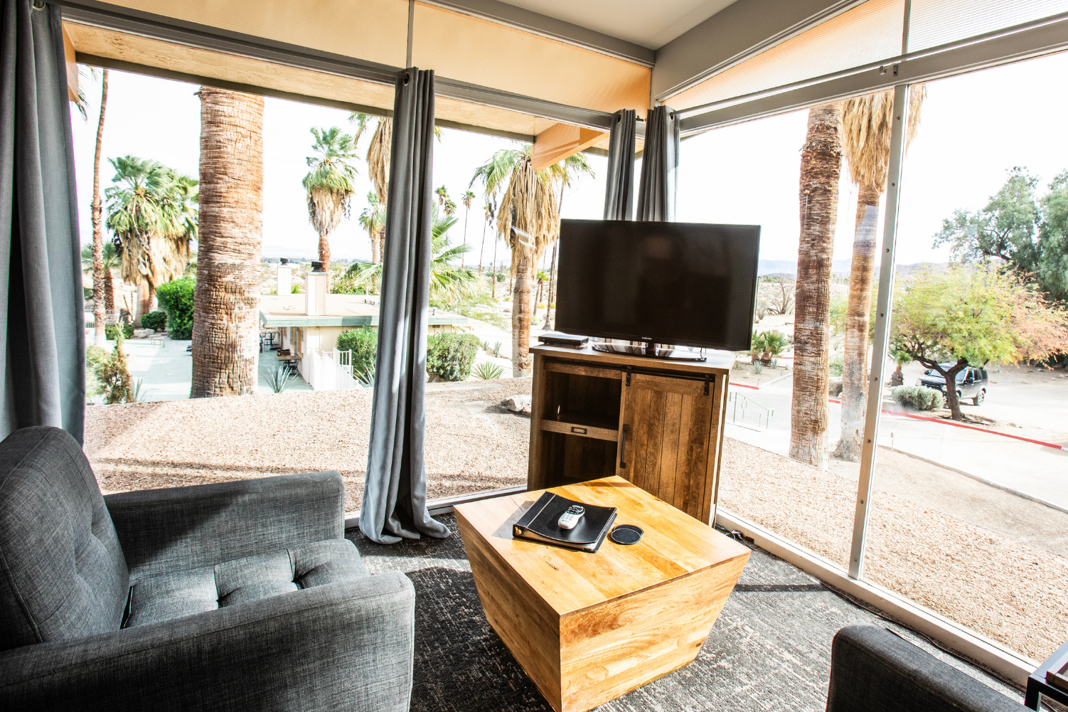 A living room with a wooden coffee table and a flat screen tv