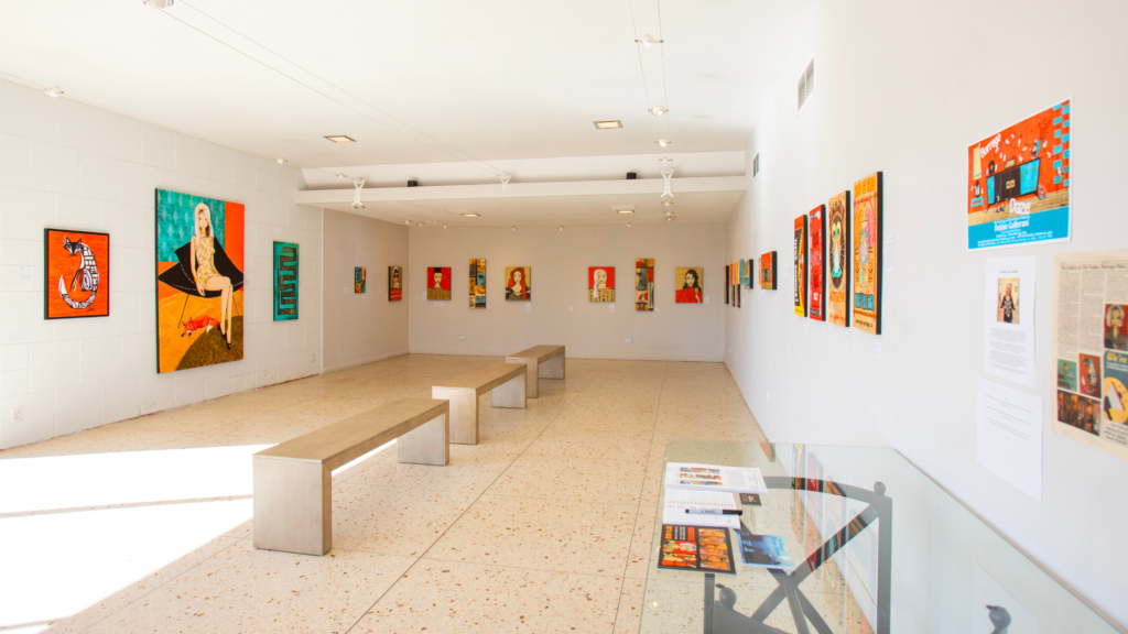 A large room with a lot of paintings on the walls.