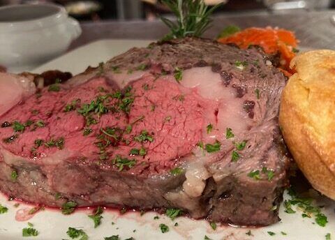 A close up of a piece of roast beef on a plate.