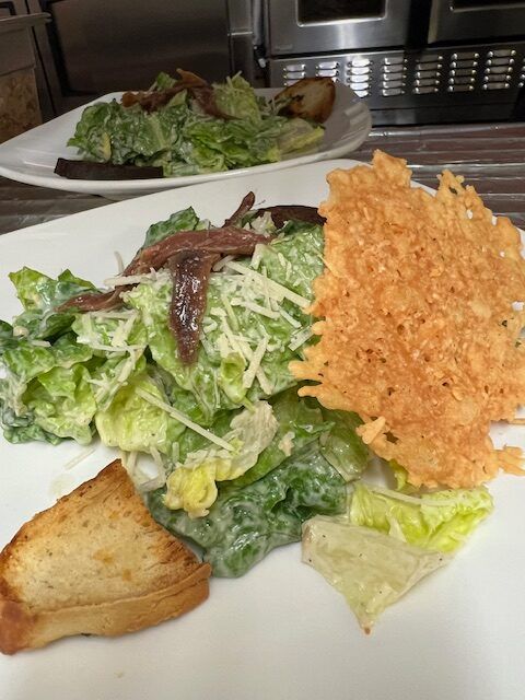 A close up of a salad with bread on a plate