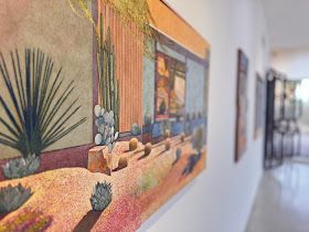 A painting is hanging on a wall in a hallway.