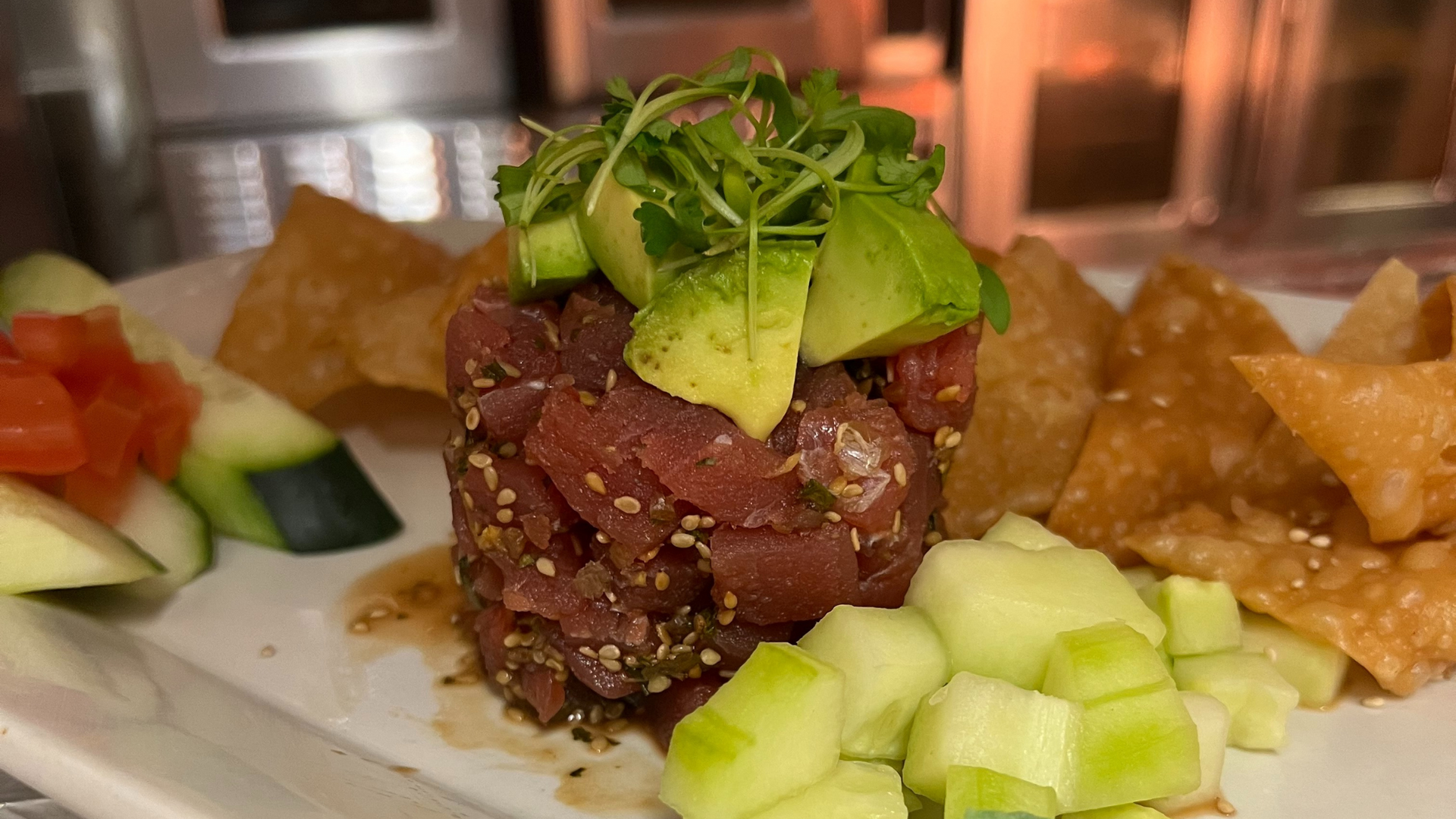 A close up of a plate of food with avocado and tortilla chips.