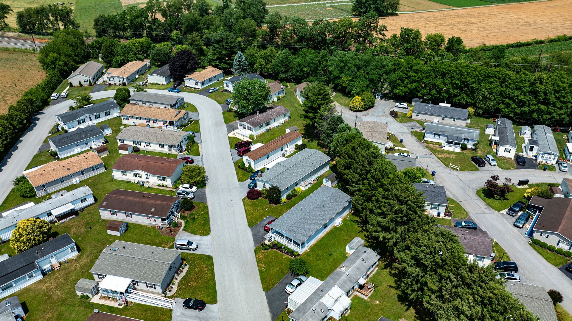 An aerial view of a mobile home park with lots of houses and trees.