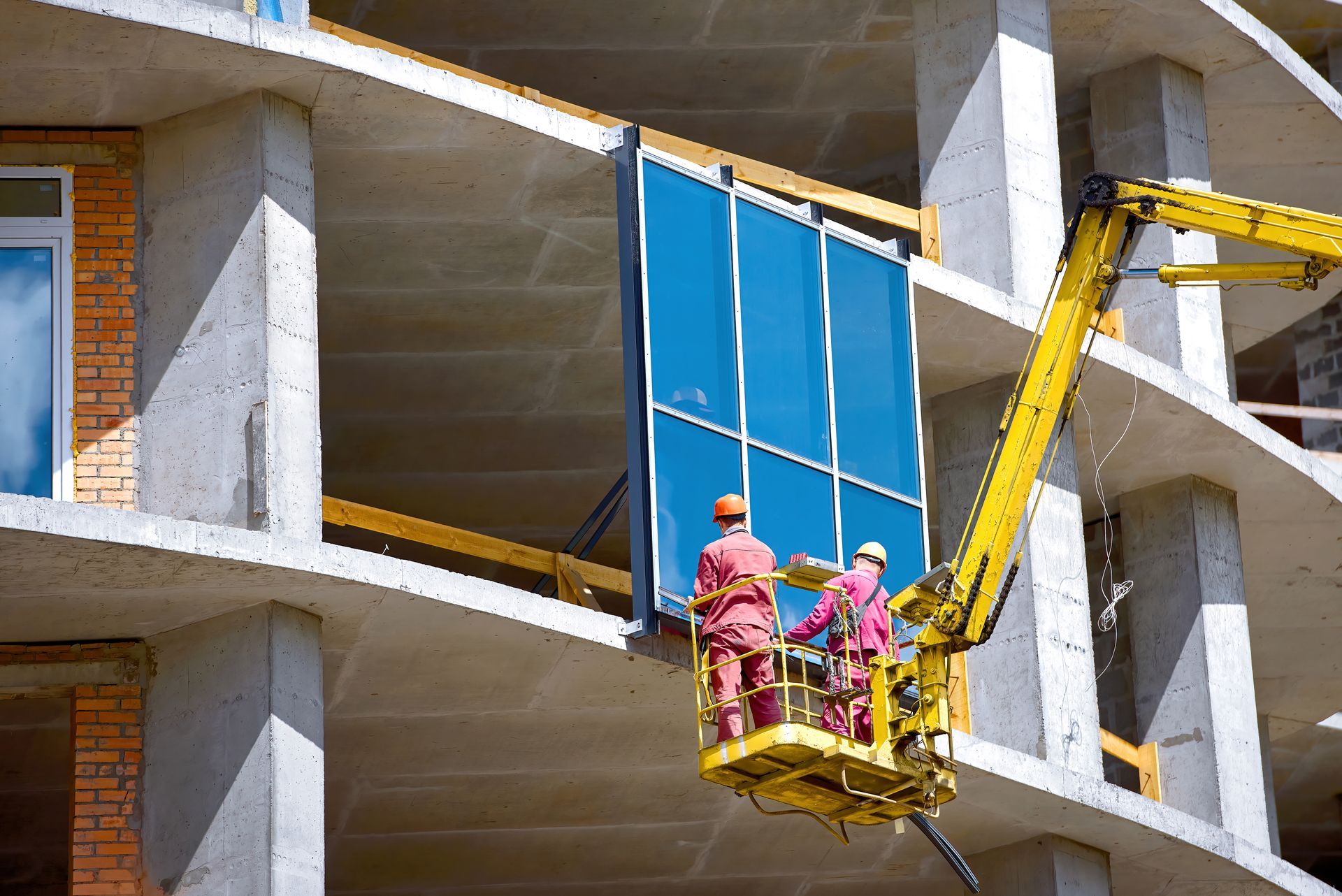A group of construction workers are working on a building.