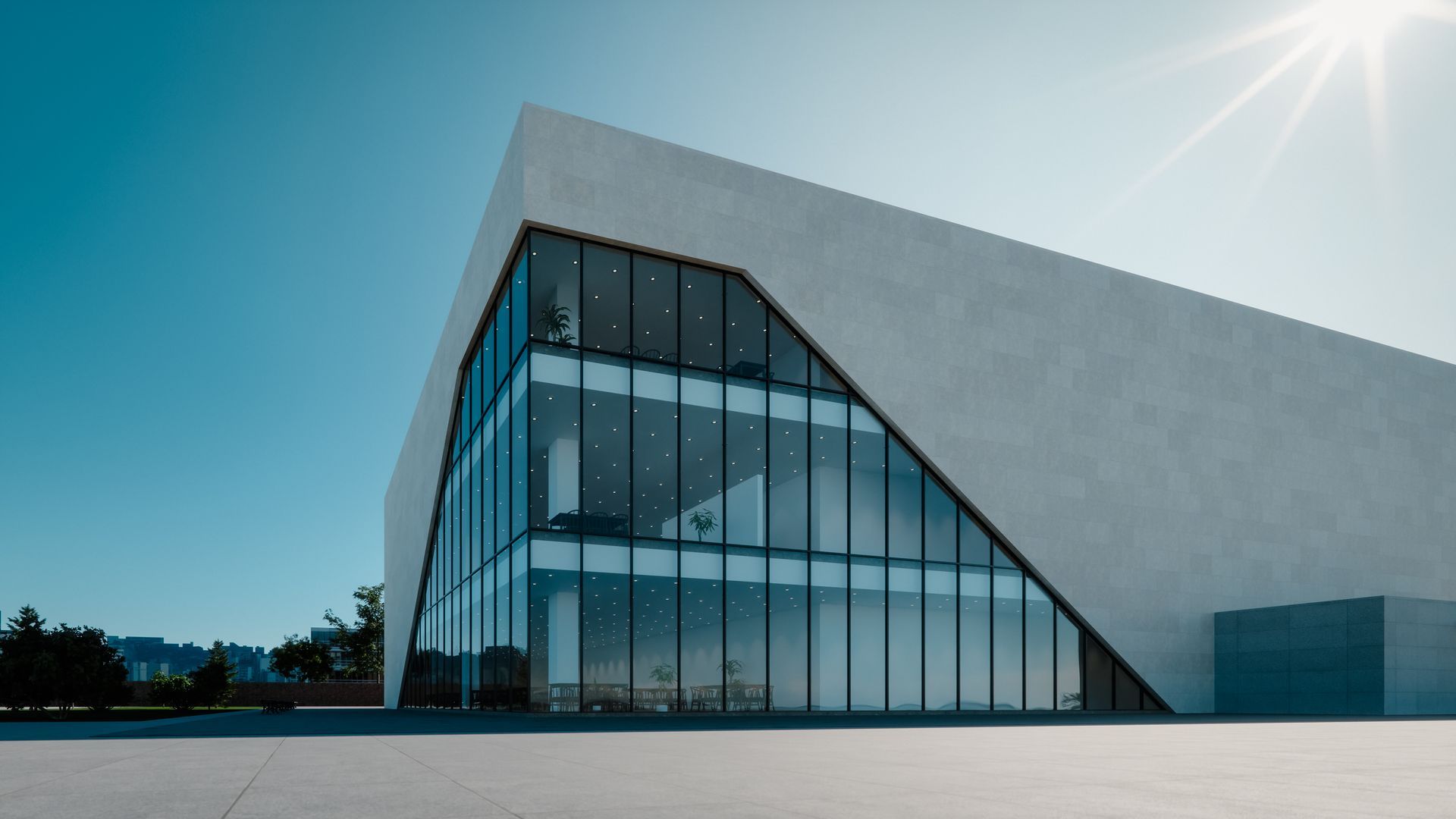A modern building with a lot of windows and a blue sky in the background.