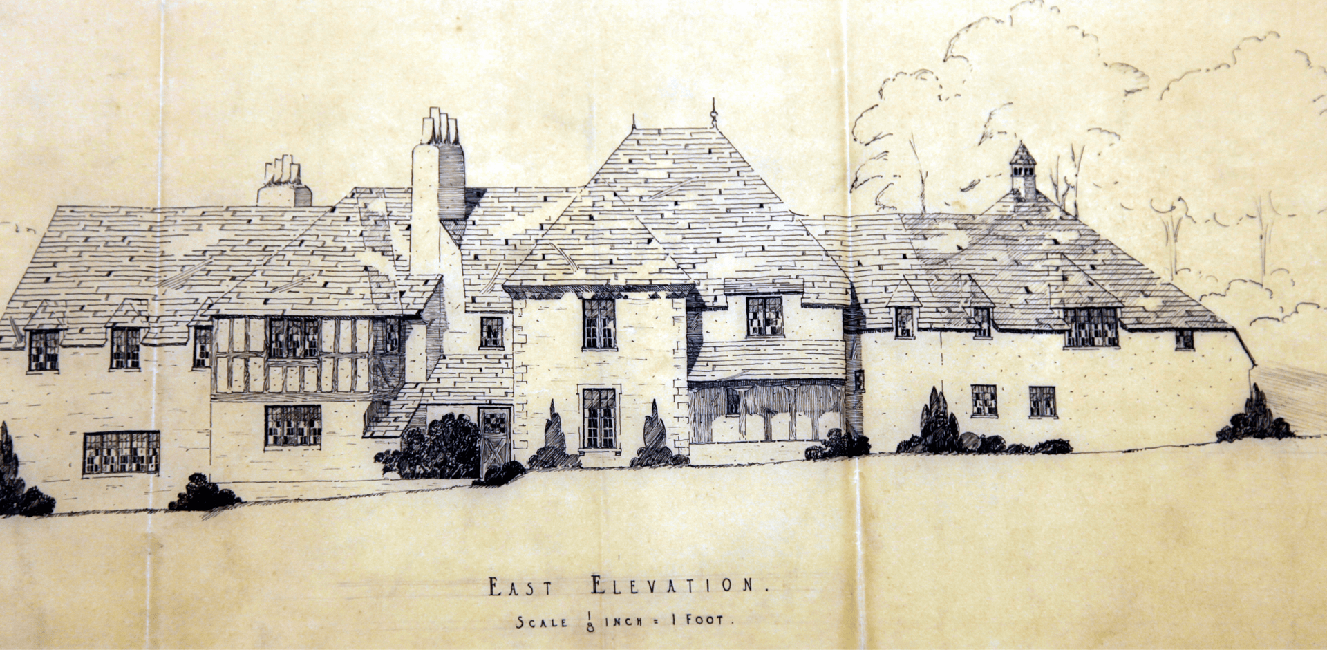 Architectural drawing of a large house with a thatched roof, Tudor style.