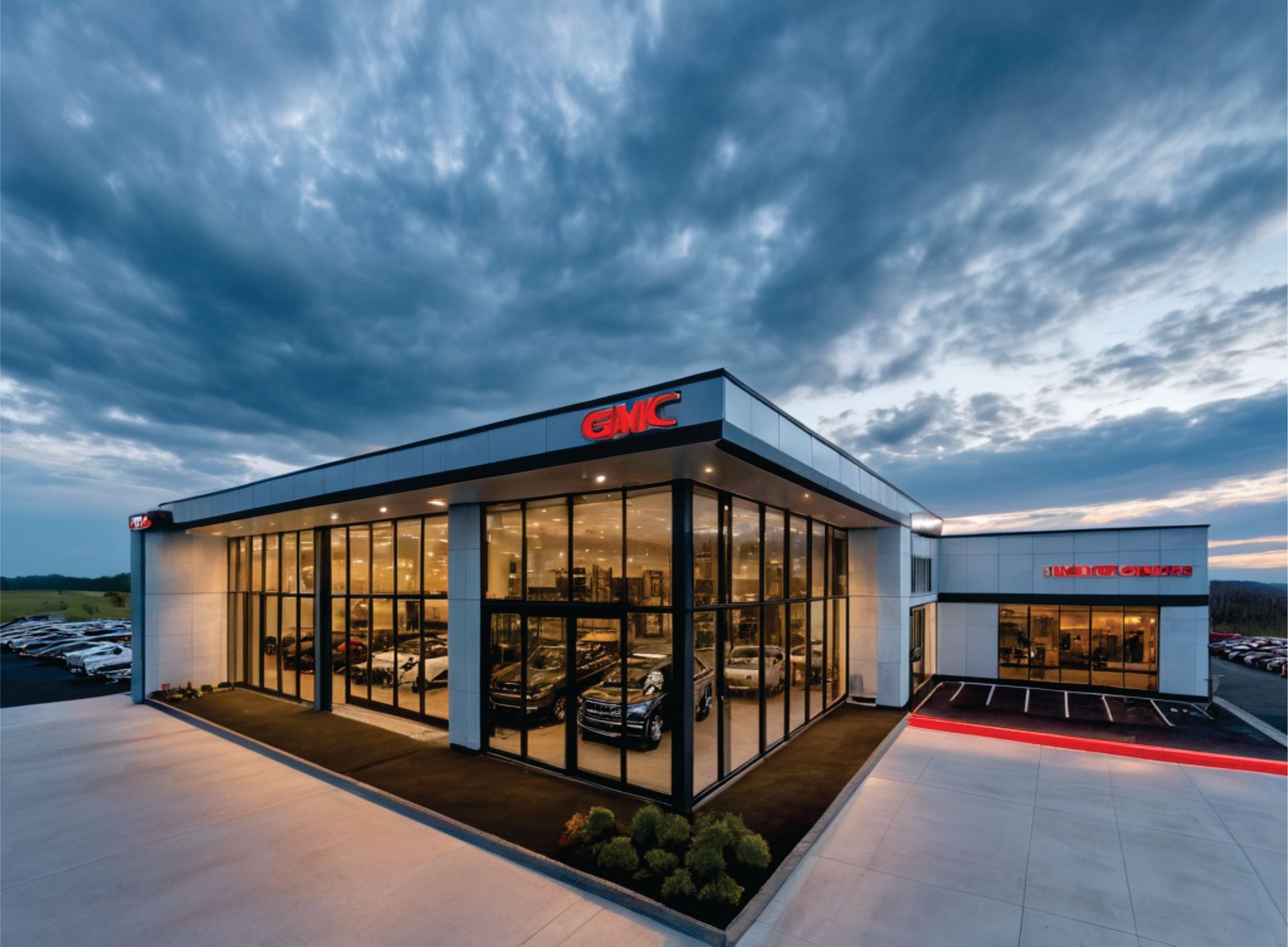 Weathered barn on a grassy hill with stone walls, surrounded by trees under a blue sky.
