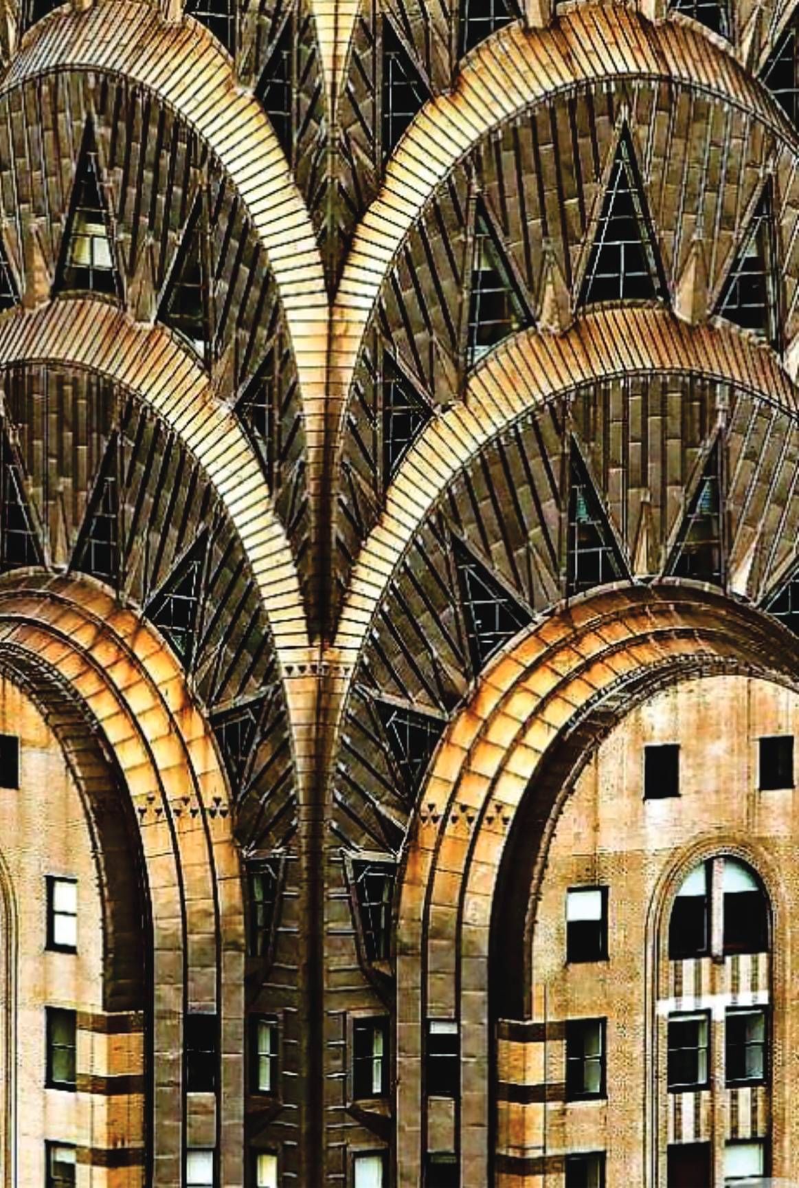 Construction team reviewing blueprints; hard hats, model house, papers on table.