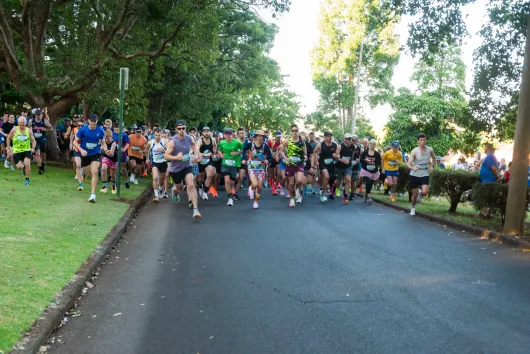 Group of people running along at the Peak2Park event