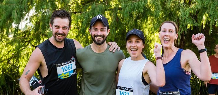 Group of people running along at the Peak2Park event