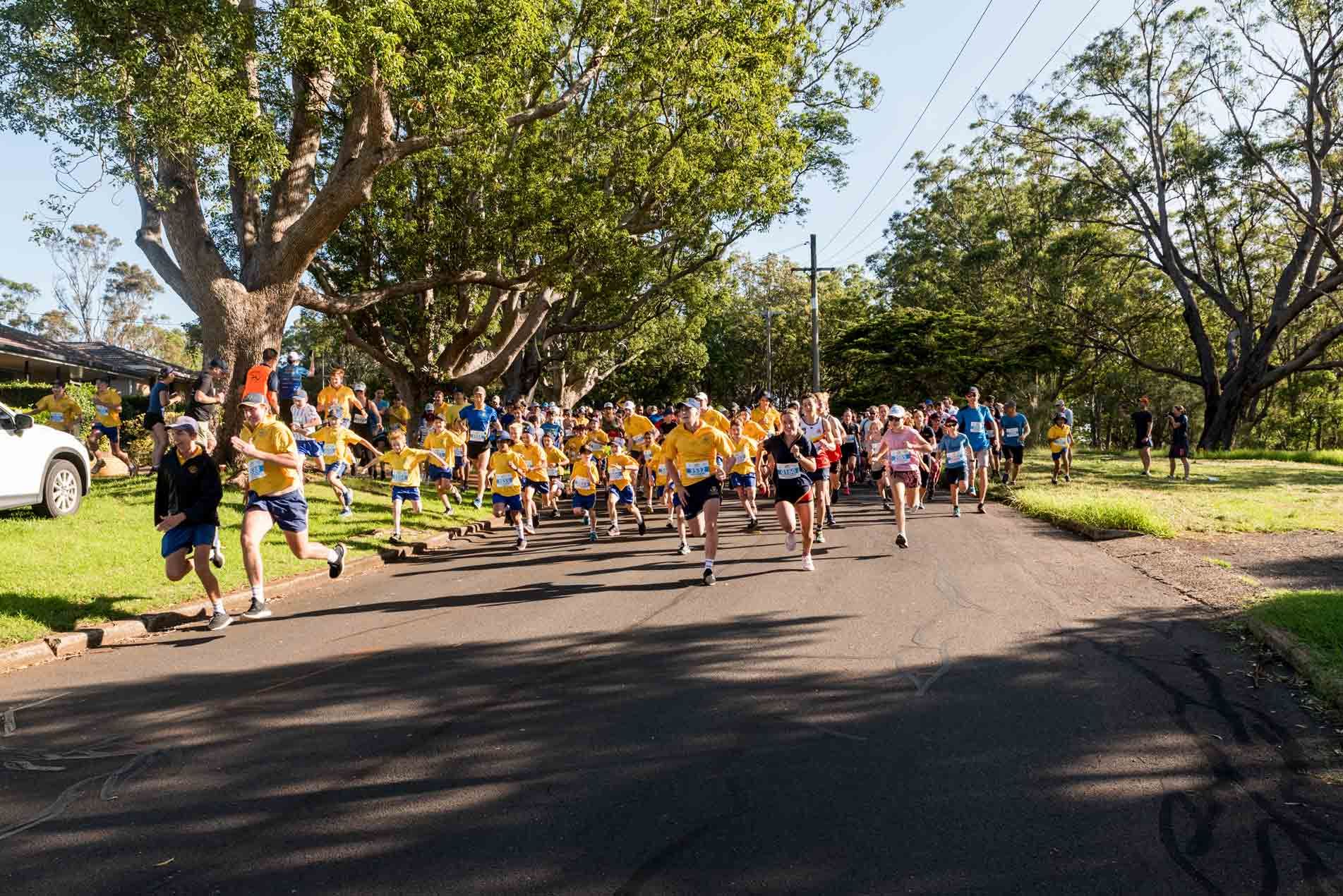 Group of people running along at the Peak2Park event