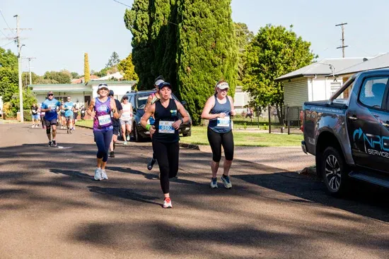 Group of people running along at the Peak2Park event
