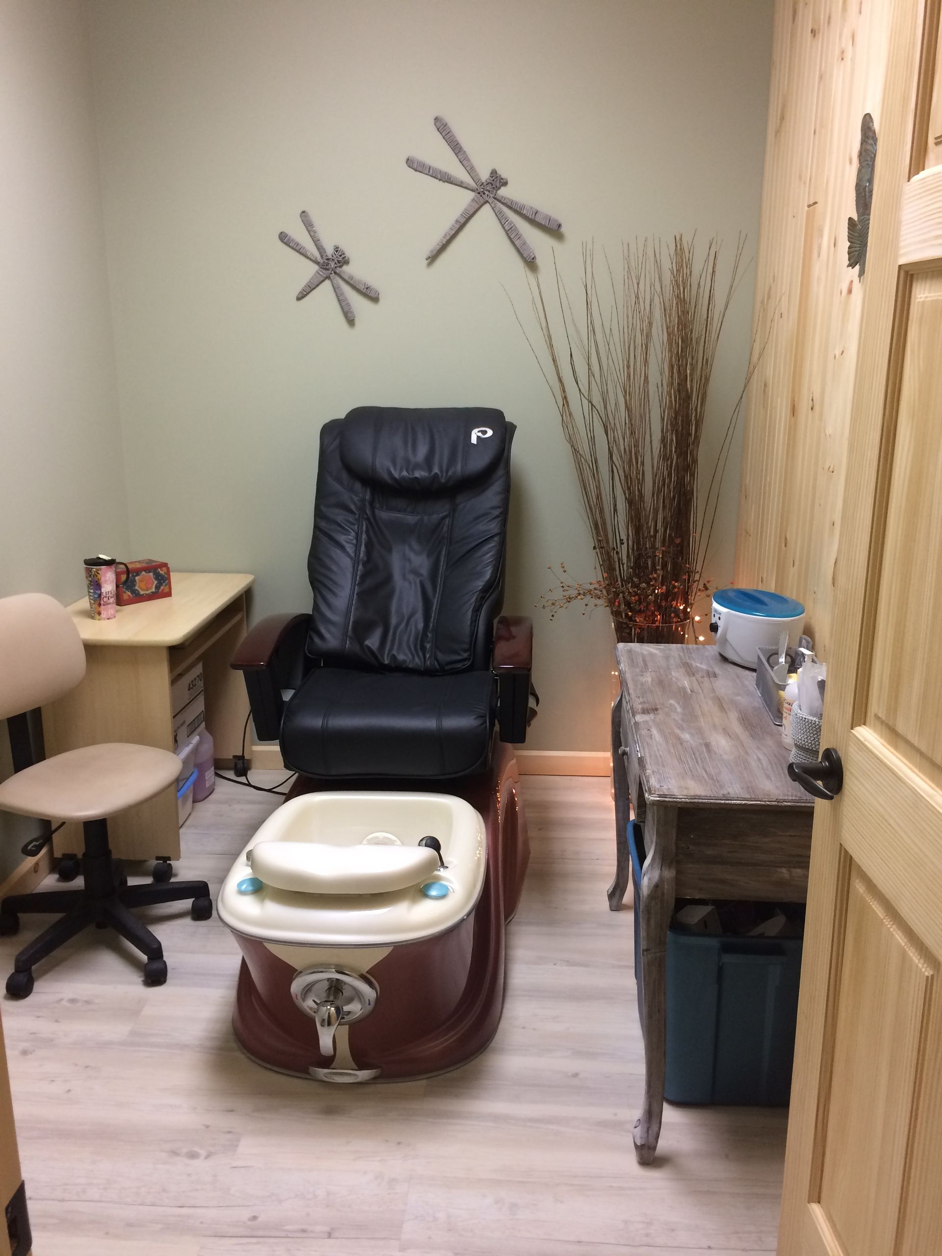 A room with a chair and a foot spa