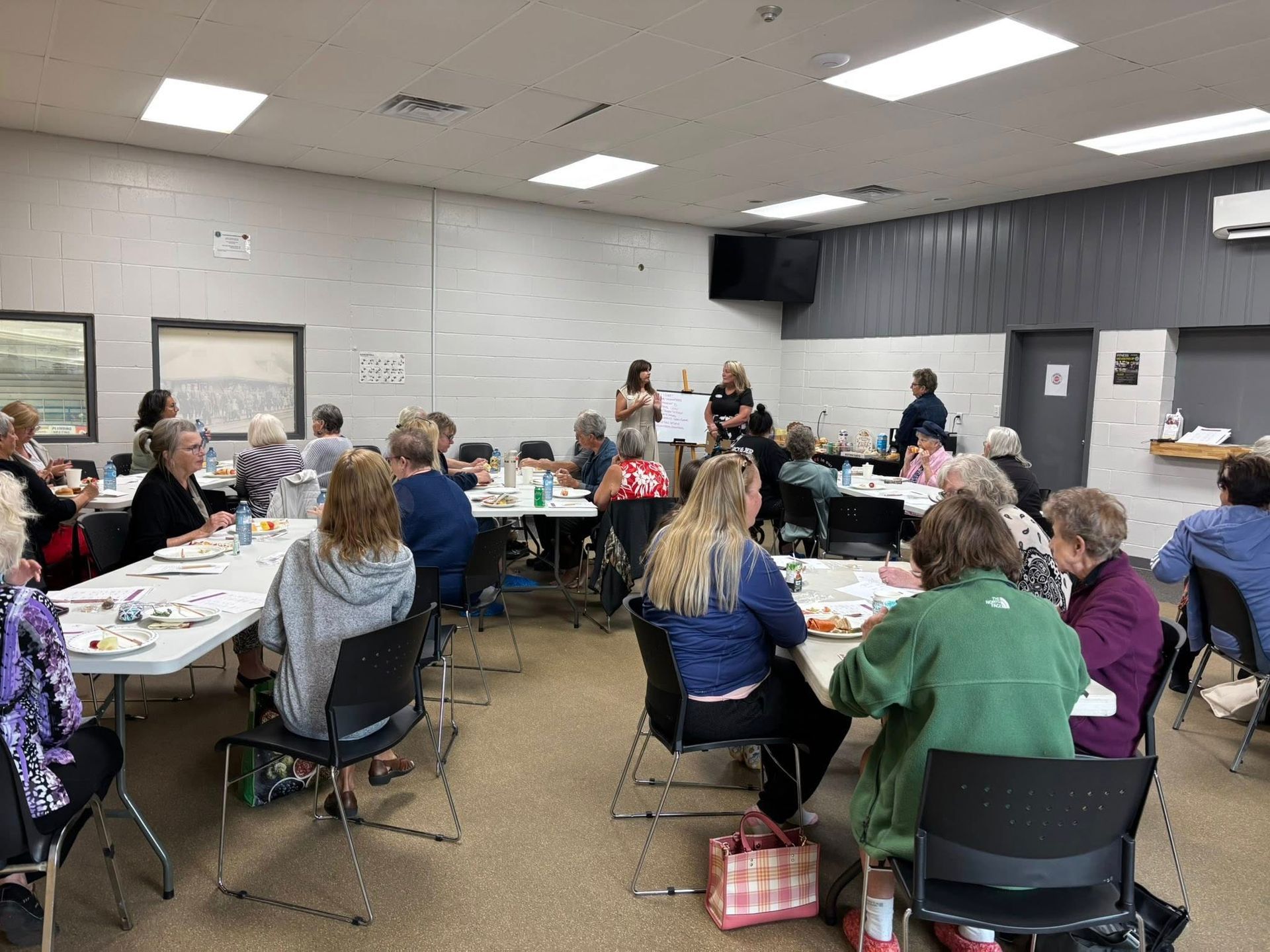 A person is putting clothes in a dryer.