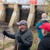 Two women and a man are posing for a picture in a store.