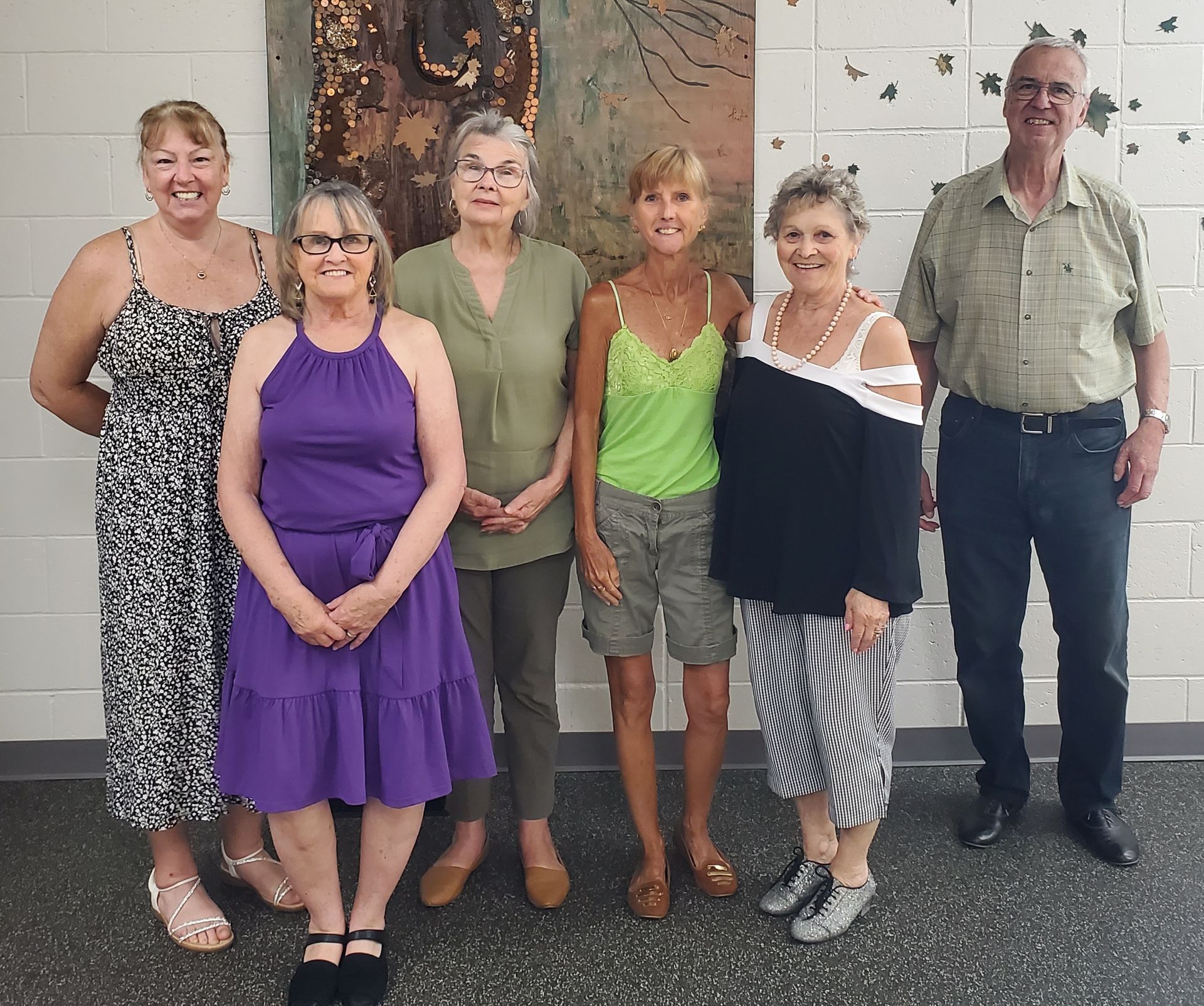 A woman wearing glasses is smiling in a store