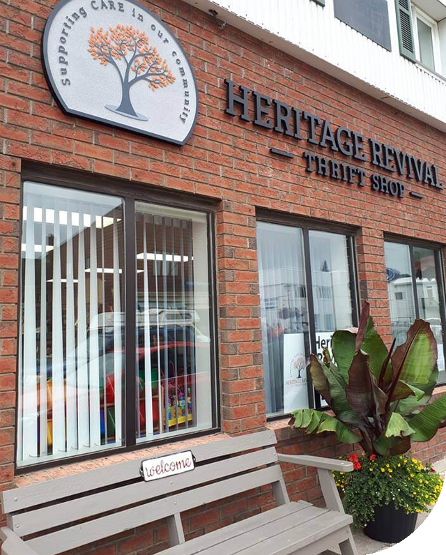 A brick building with a sign that says heritage revival thrift shop