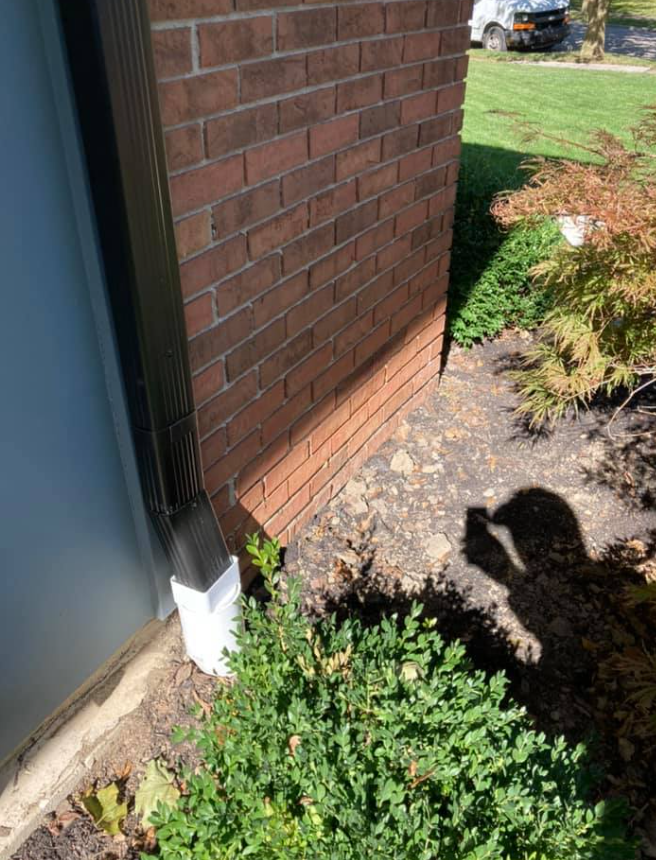 A Brick Wall With A Black Gutter On It | Pickerington, OH | Drainco LLC