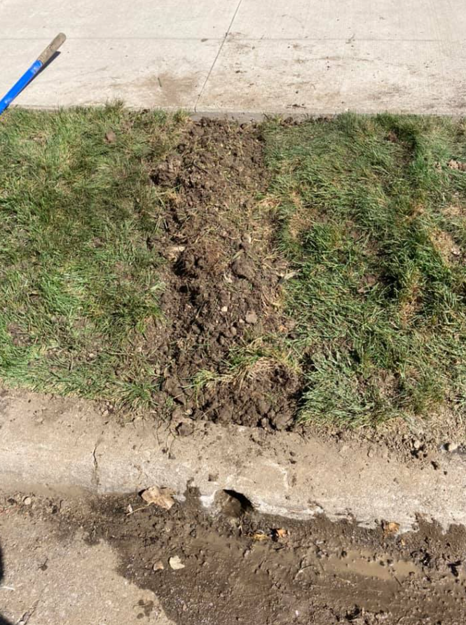 A Blue Shovel Is Sitting On A Sidewalk Next To A Patch Of Grass | Pickerington, OH | Drainco LLC