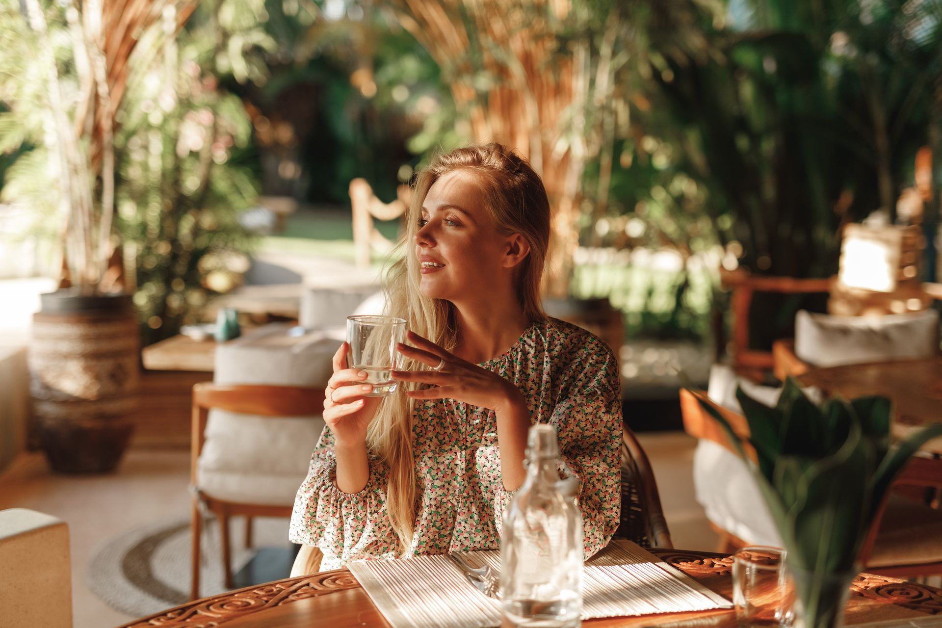 Woman in floral top seated at table