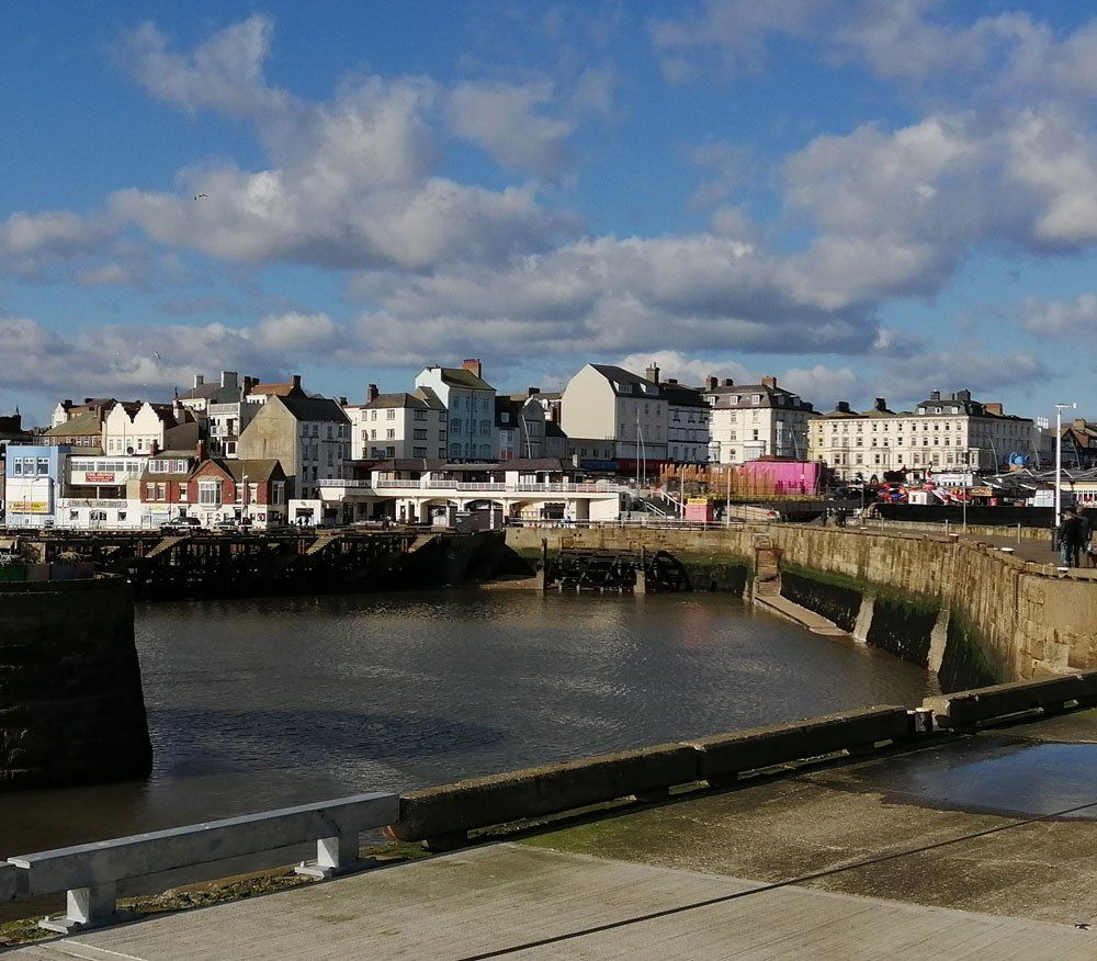High Angle View Of River By Buildings Against Sky
