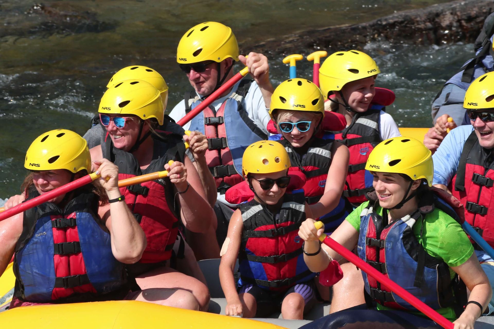 A group of people are riding a raft down a river.