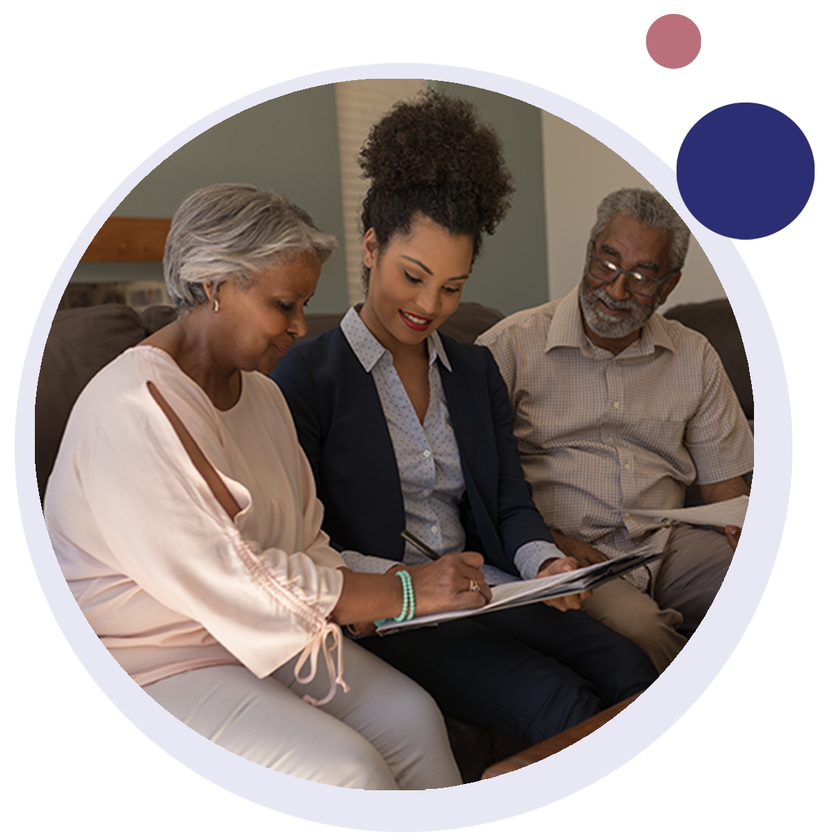 An advisor sits and talks an older couple through estate planning documents