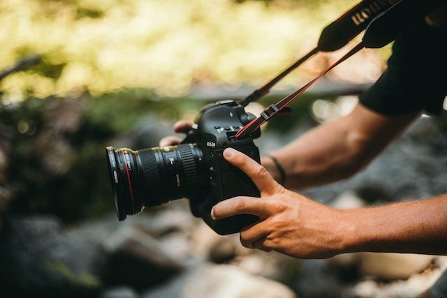 man taking a photo with the canon eos-1dx mark iii