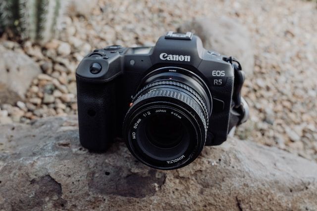 canon eos r5 sitting on top of a rock