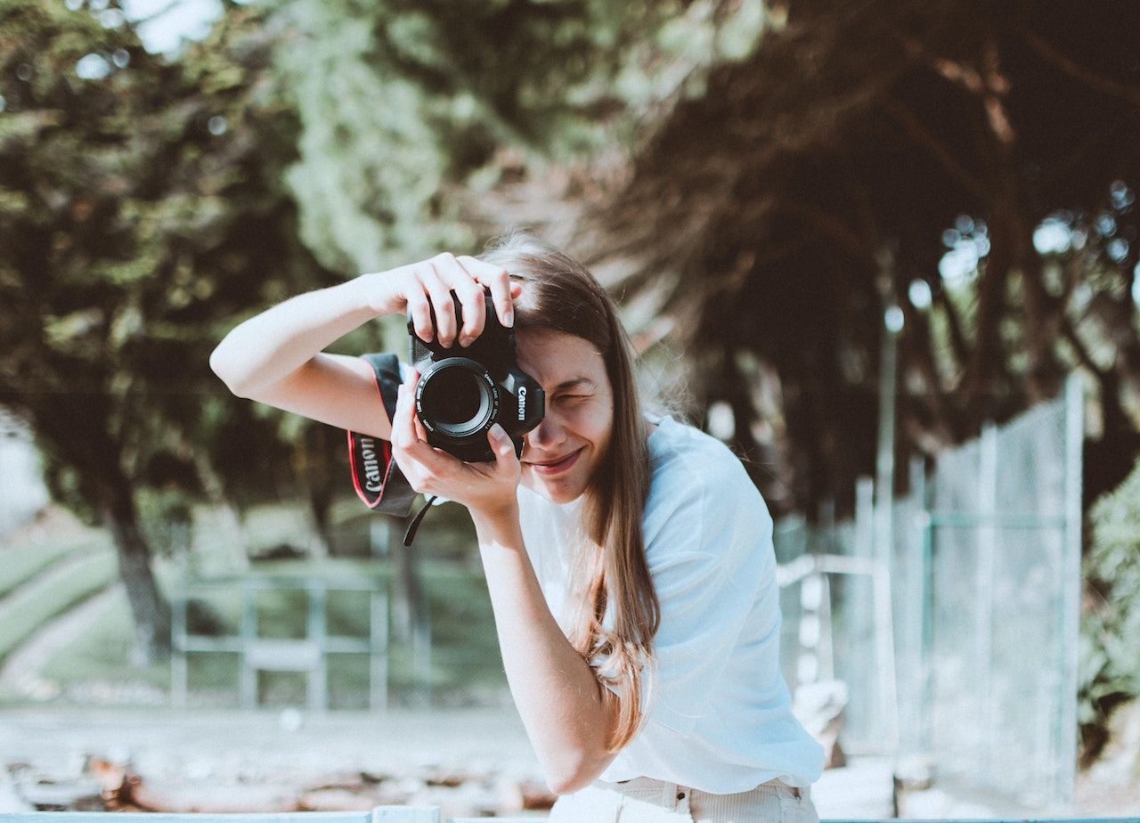 woman taking a picture with the canon eos rebel t7i