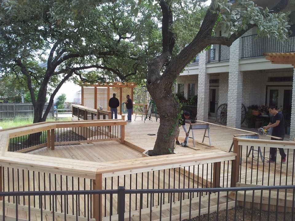 A wooden deck is being built in front of a house