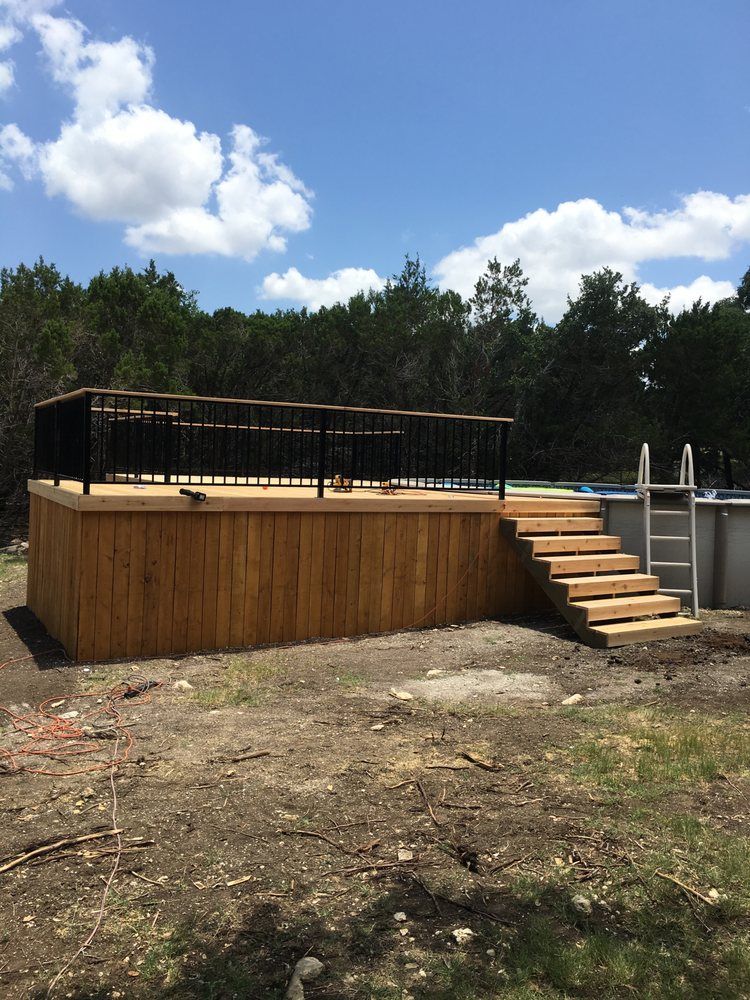 A wooden deck with stairs next to a pool