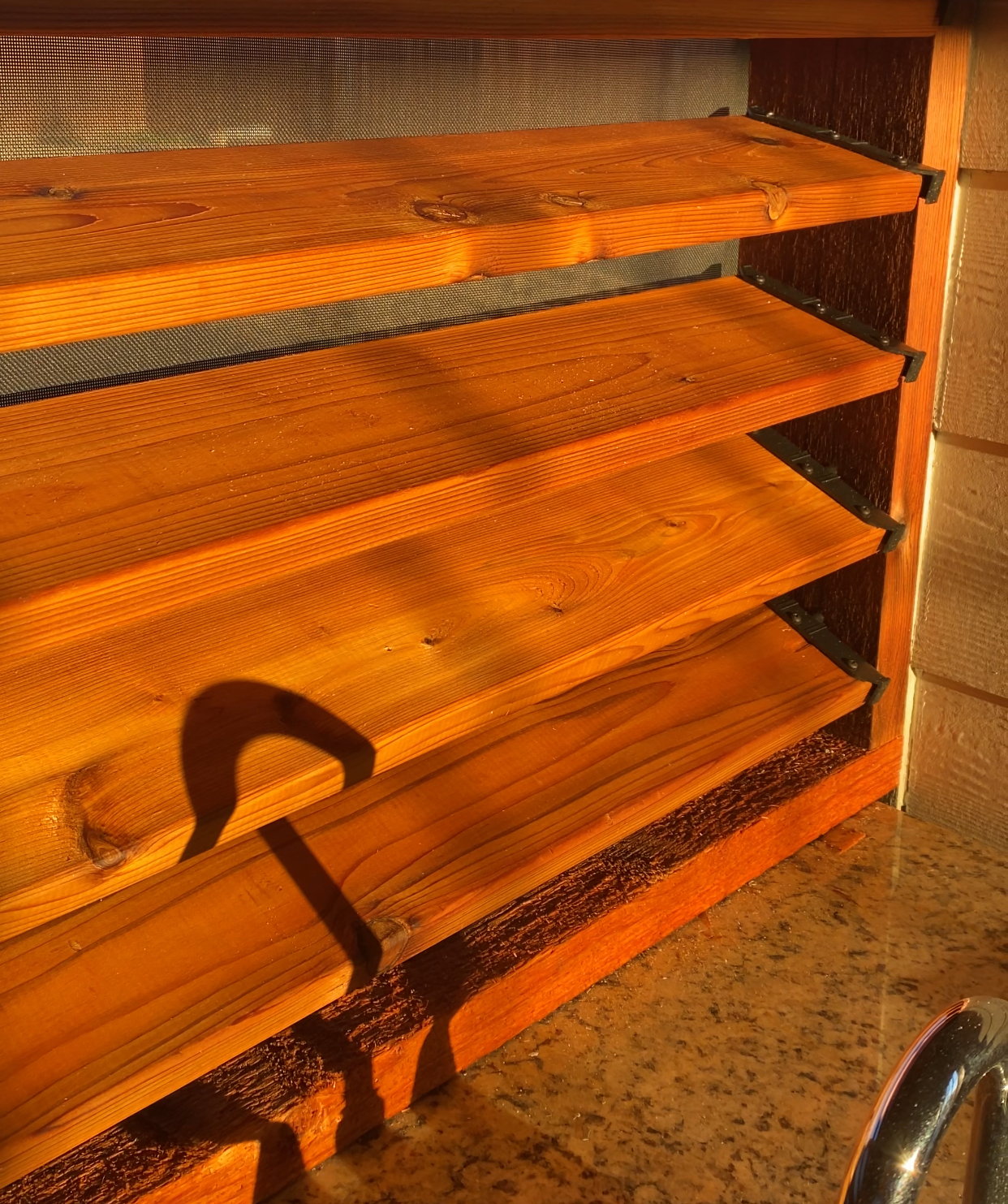 A wooden shelf is sitting on a counter top