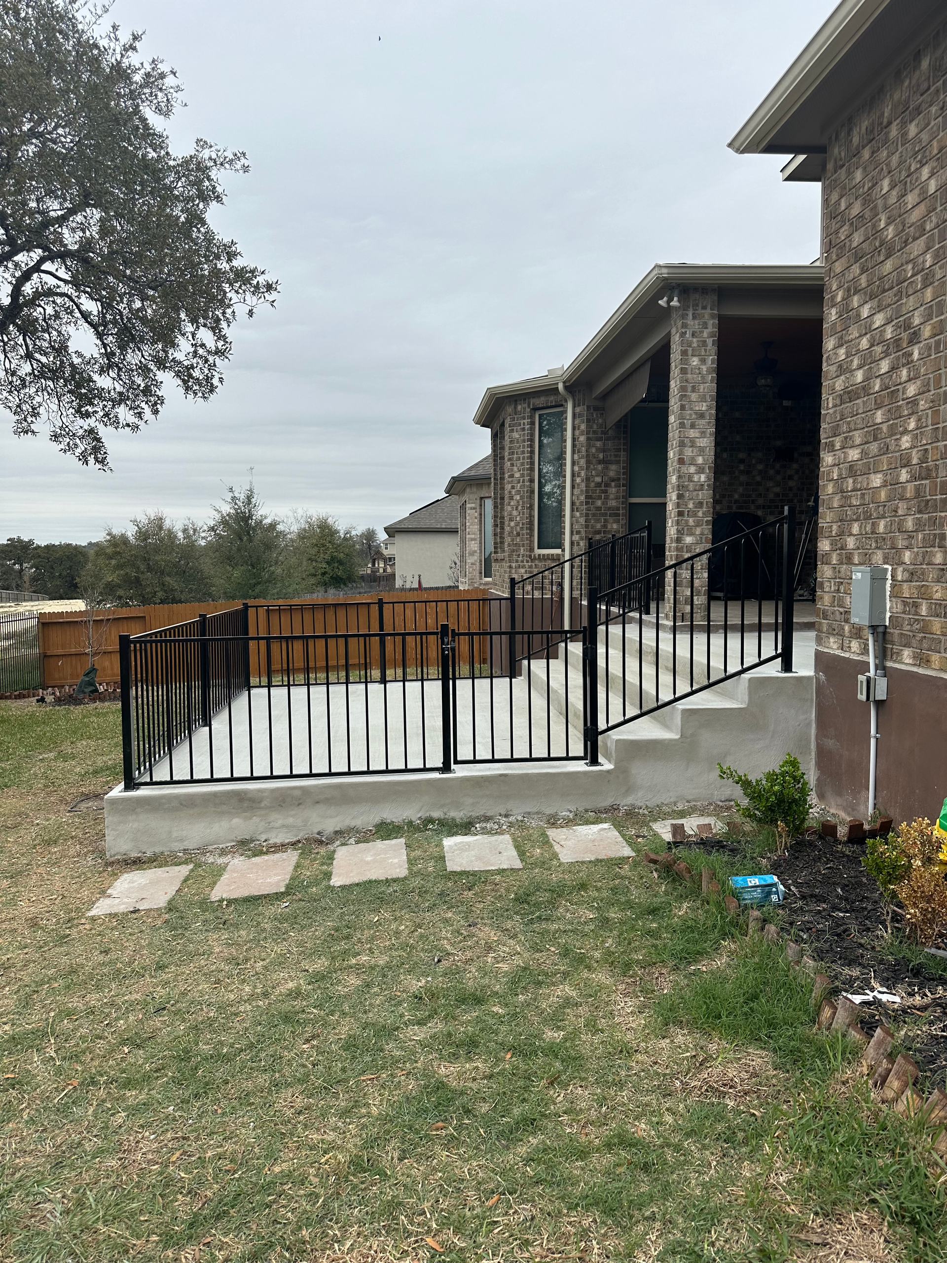 A house with a patio and stairs in the backyard.