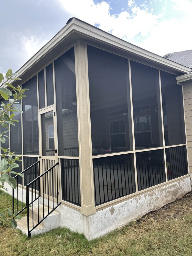 A screened in porch with stairs leading up to it.