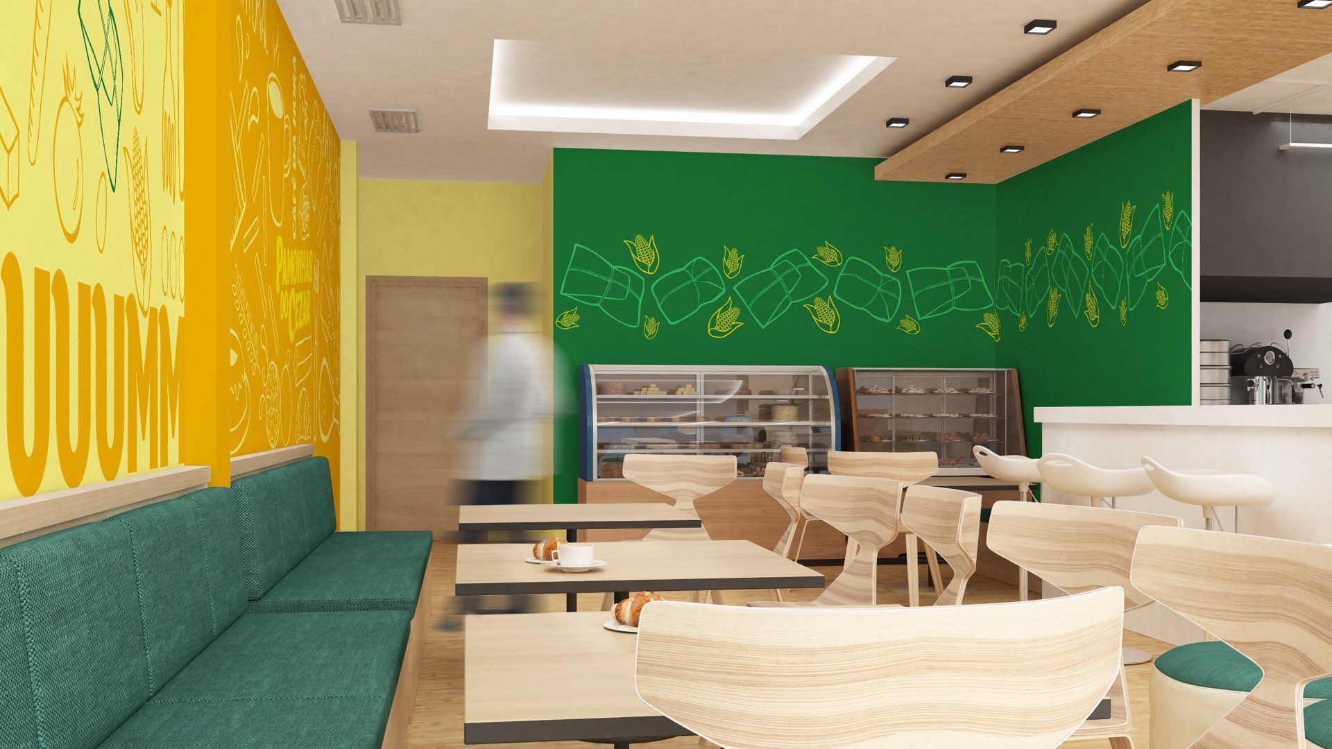 Interior de um café com cores vibrantes, paredes verdes e amarelas, móveis de madeira e uma pessoa desfocada ao fundo.