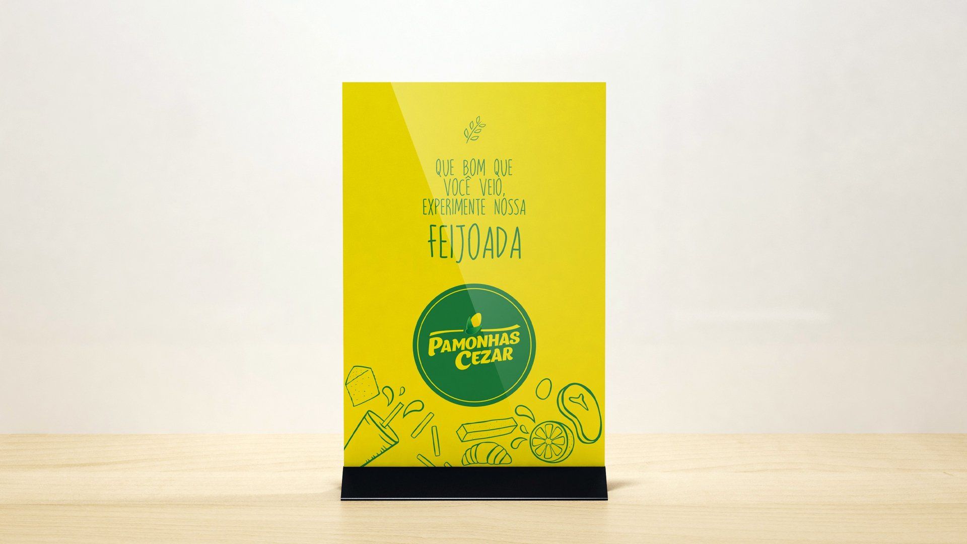 Uma mesa amarela com texto verde e um logotipo. O texto diz