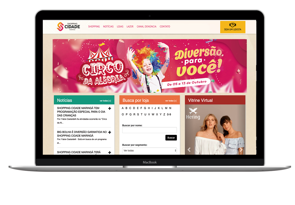 Laptop displaying a website with a colorful circus theme, including text